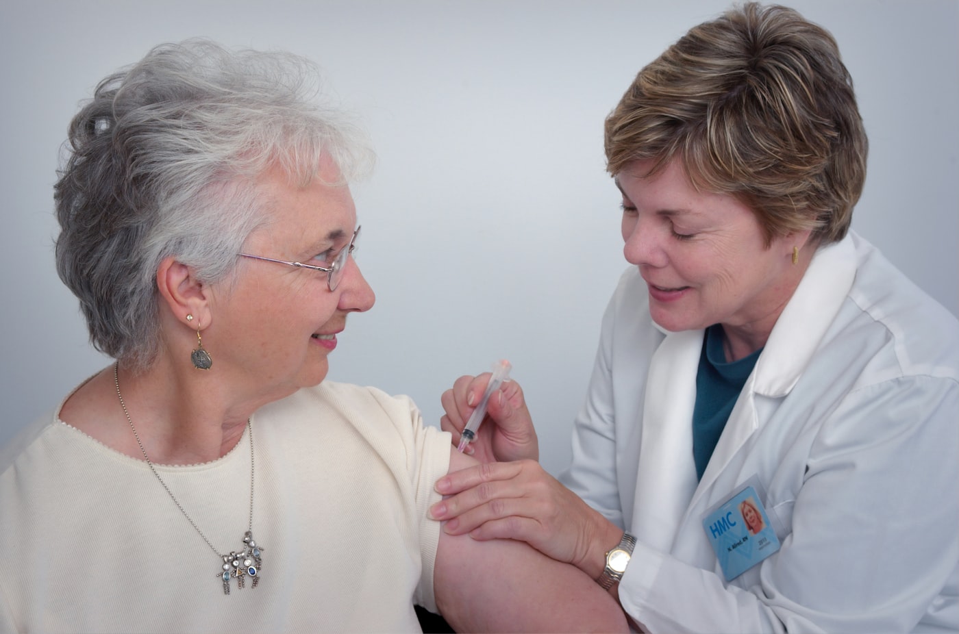 A nurse supporting an older lady at home